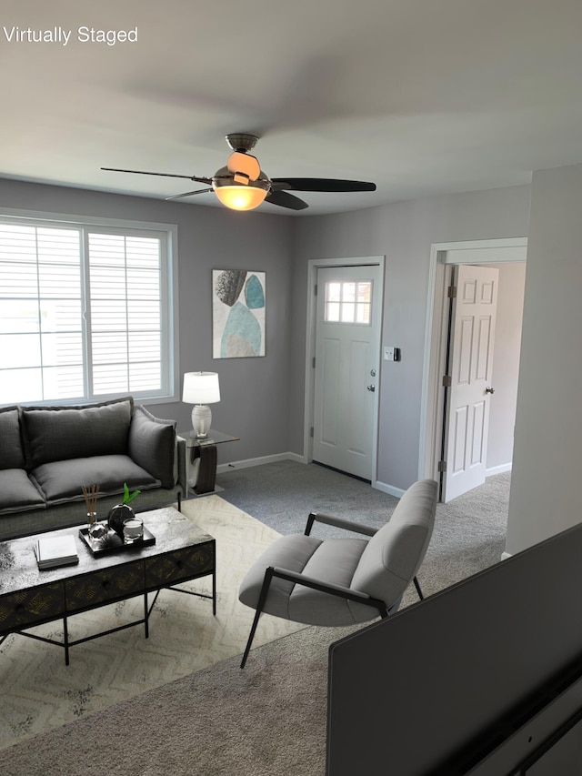 carpeted living room with a wealth of natural light and ceiling fan