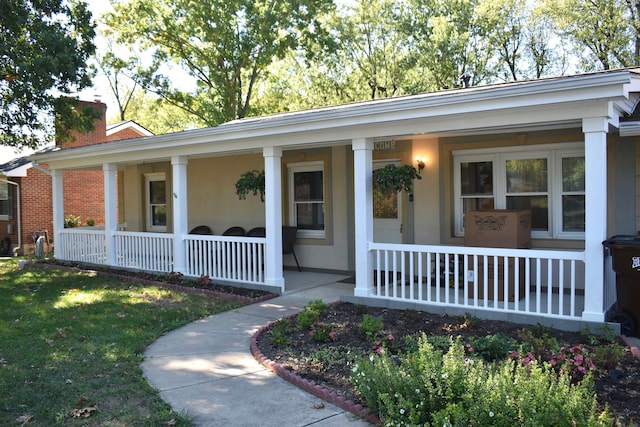 single story home featuring covered porch and a front yard