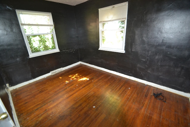 unfurnished room featuring hardwood / wood-style floors