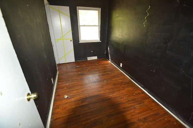 unfurnished room featuring dark hardwood / wood-style flooring