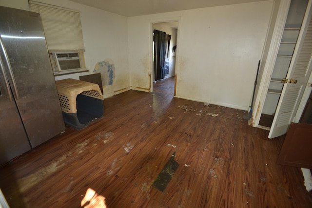 unfurnished dining area with cooling unit and dark hardwood / wood-style floors