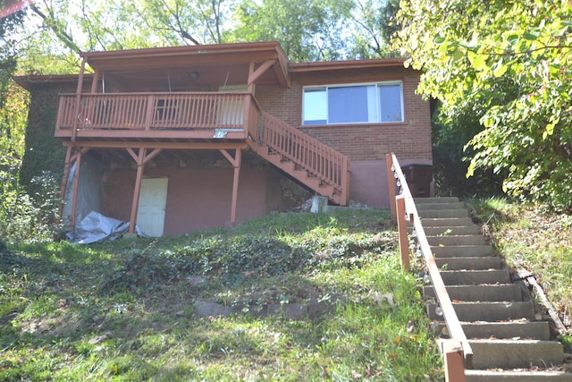 back of property featuring a wooden deck