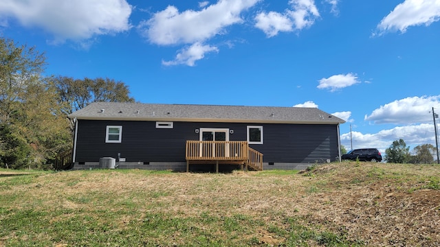 rear view of house with a wooden deck, a lawn, and cooling unit