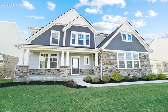 craftsman-style house with a front lawn and a porch