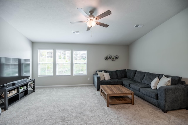 carpeted living room featuring ceiling fan