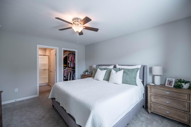 carpeted bedroom featuring connected bathroom, ceiling fan, a walk in closet, and a closet