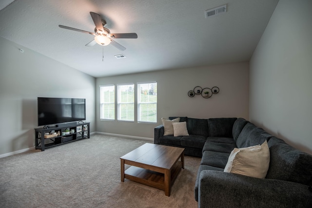 living room featuring vaulted ceiling, carpet flooring, and ceiling fan