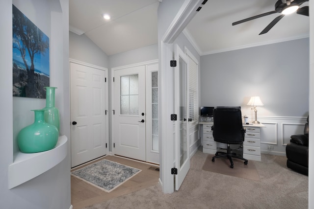 carpeted home office with crown molding, vaulted ceiling, and ceiling fan