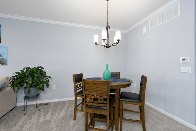 dining room with crown molding, carpet, and an inviting chandelier