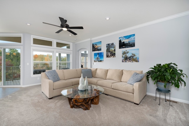 living room featuring crown molding, light colored carpet, and ceiling fan