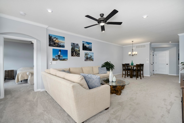 carpeted living room with ornamental molding and ceiling fan with notable chandelier