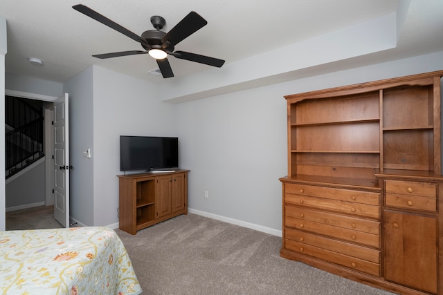 unfurnished bedroom with ceiling fan and light colored carpet