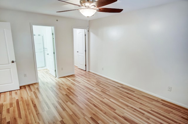 unfurnished bedroom with ensuite bathroom, ceiling fan, and light hardwood / wood-style floors