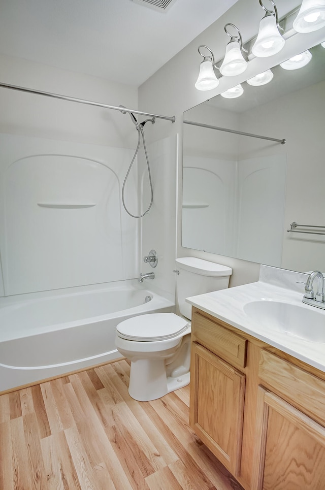 full bathroom featuring toilet, bathtub / shower combination, a chandelier, vanity, and hardwood / wood-style floors