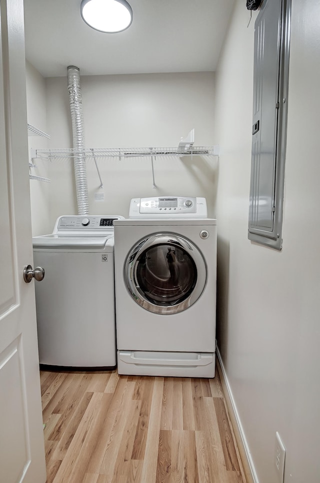 laundry room featuring light hardwood / wood-style floors and washer and dryer