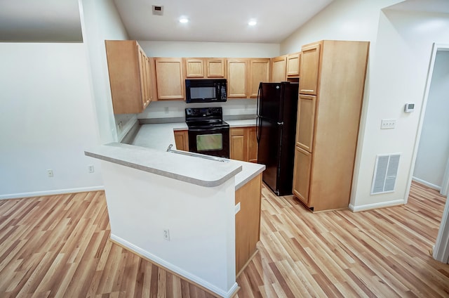 kitchen featuring sink, light hardwood / wood-style floors, black appliances, kitchen peninsula, and light brown cabinets