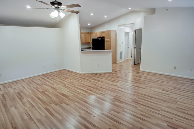 unfurnished living room featuring ceiling fan, lofted ceiling, and light wood-type flooring