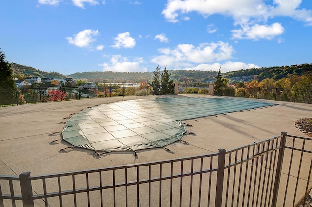 view of pool featuring a mountain view and a patio