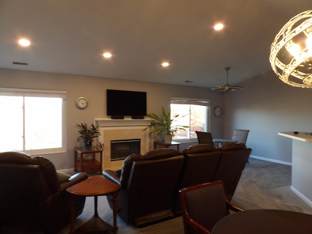 living room featuring ceiling fan and dark colored carpet