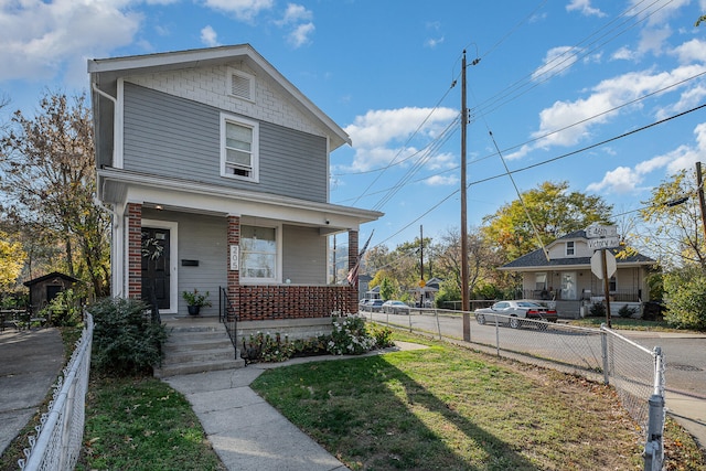 view of front facade featuring a front lawn and a porch