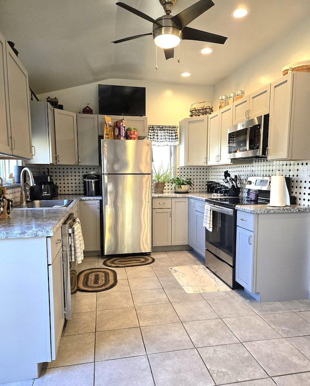 kitchen featuring sink, decorative backsplash, ceiling fan, light tile patterned floors, and stainless steel appliances