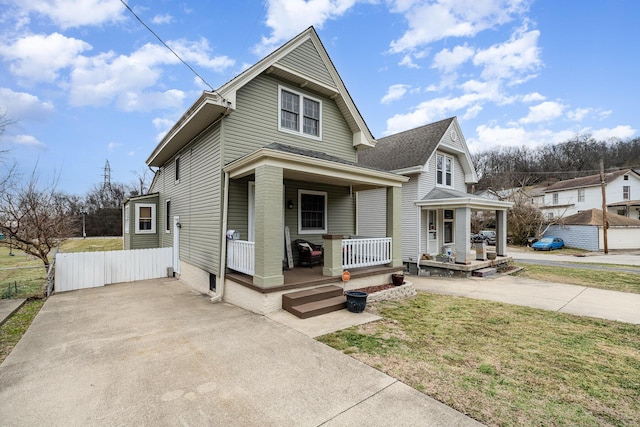 view of front of property with a front yard and covered porch