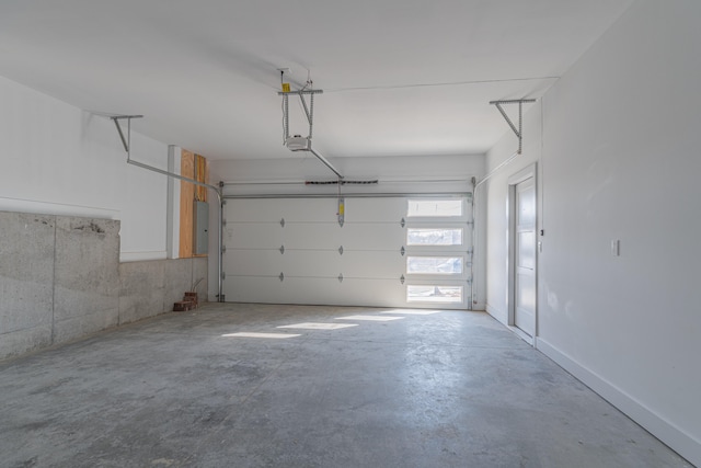 garage featuring electric panel and a garage door opener