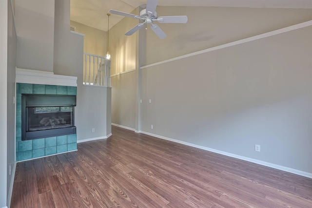 unfurnished living room featuring a tiled fireplace, ceiling fan, high vaulted ceiling, and hardwood / wood-style flooring