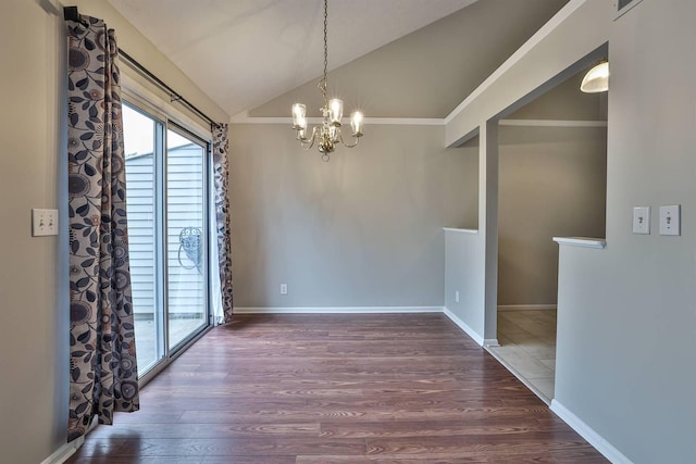 unfurnished dining area featuring dark wood-type flooring, vaulted ceiling, and a chandelier