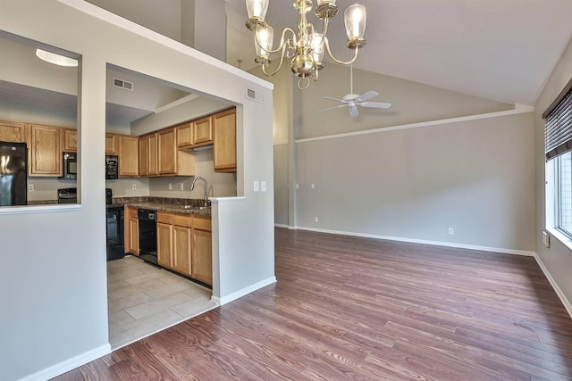 kitchen featuring black appliances, high vaulted ceiling, light wood-type flooring, ceiling fan with notable chandelier, and sink