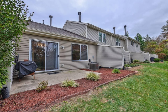 back of house with a patio, central air condition unit, and a lawn