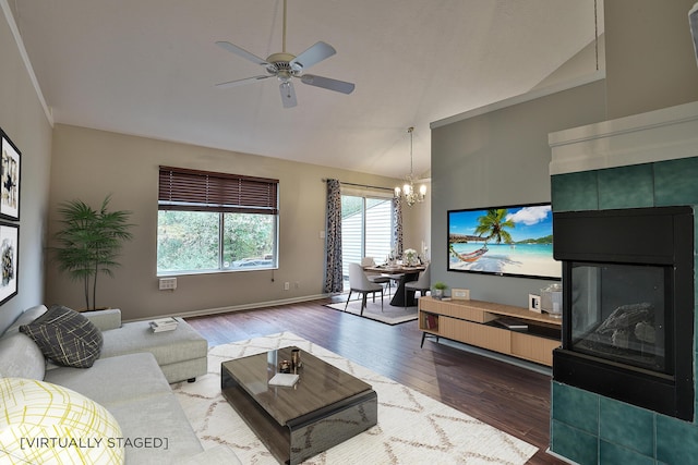 living room featuring lofted ceiling, ceiling fan with notable chandelier, and hardwood / wood-style flooring