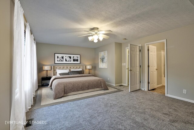 bedroom with light colored carpet, ceiling fan, and a textured ceiling