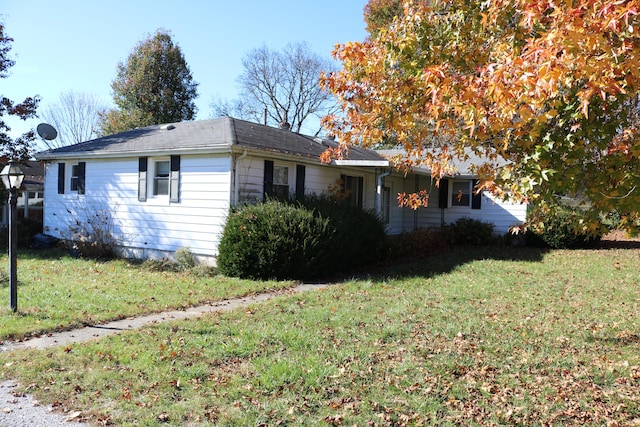 view of side of home featuring a yard