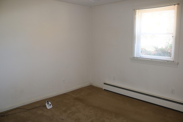 carpeted spare room with baseboard heating