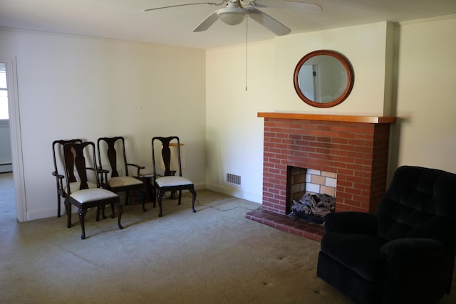 living area with carpet floors, a fireplace, and ceiling fan