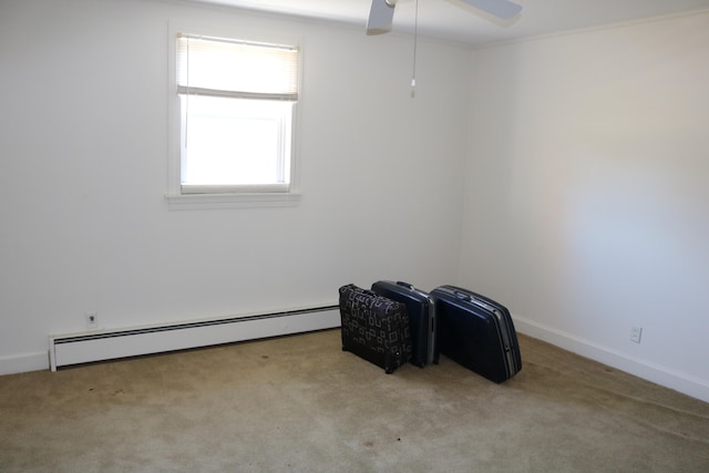 spare room featuring light carpet, a baseboard radiator, and ceiling fan