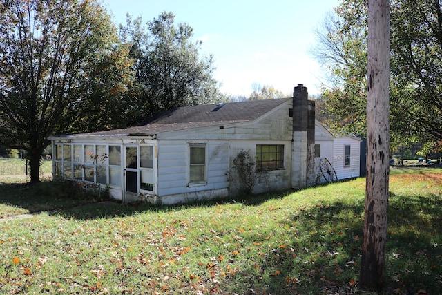 rear view of property with a yard