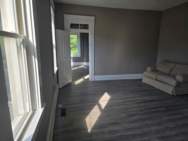 unfurnished living room featuring dark hardwood / wood-style floors