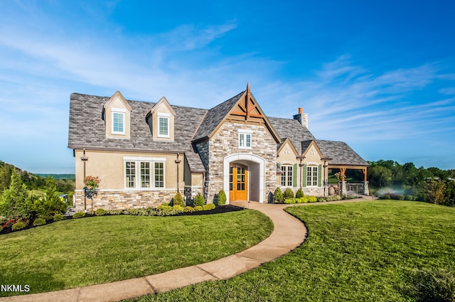 view of front facade with stone siding, french doors, a front yard, and stucco siding