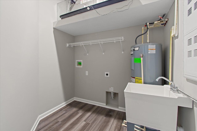 washroom featuring laundry area, dark wood finished floors, electric water heater, hookup for a washing machine, and a sink