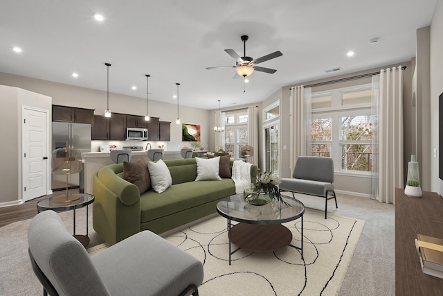 living room featuring ceiling fan, baseboards, visible vents, and recessed lighting