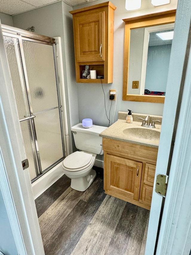 bathroom with vanity, wood-type flooring, an enclosed shower, and toilet