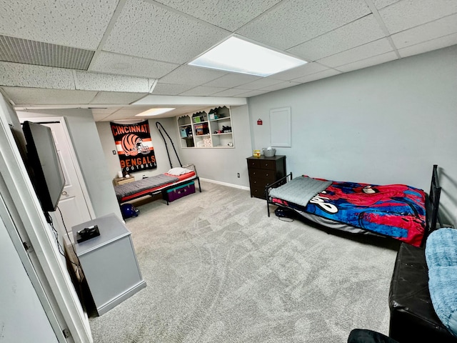 bedroom with a paneled ceiling and carpet