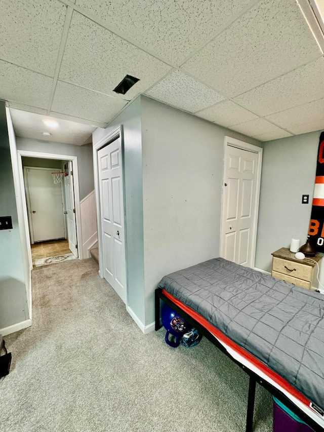 bedroom with carpet and a drop ceiling