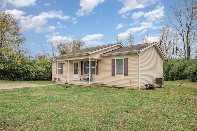 ranch-style home featuring a front yard, central AC, and covered porch