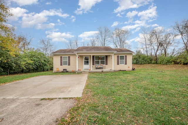 ranch-style house featuring a porch and a front yard