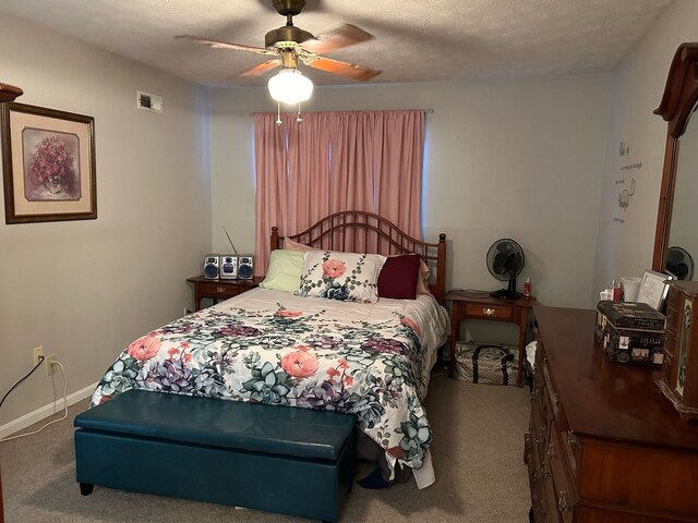 carpeted bedroom featuring a textured ceiling and ceiling fan