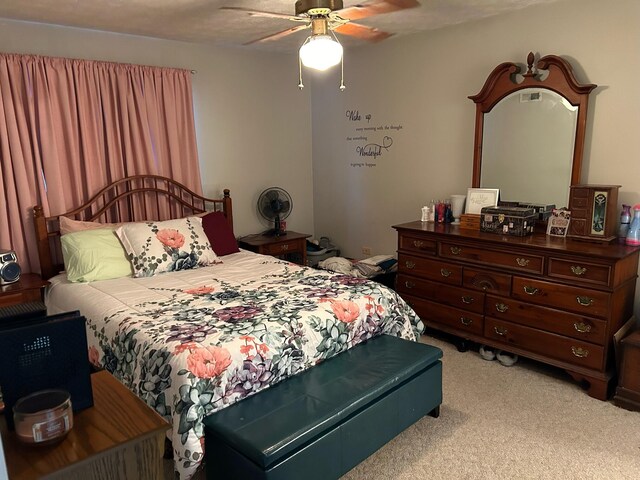 bedroom with ceiling fan and light carpet