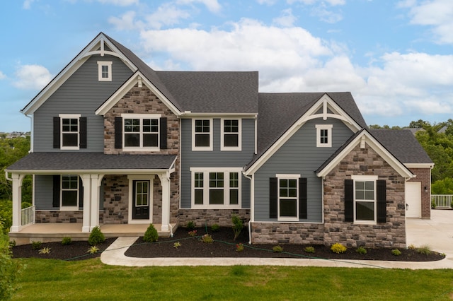 craftsman-style home featuring a front lawn and covered porch